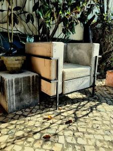 an old bench sitting on a stone ground at VILLA DA FONTE - BY MECO in Alfarim
