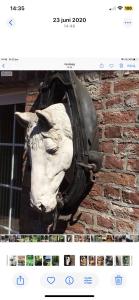 a bust of a head hanging on a brick wall at Althuizenhof - Jelle in Doenrade
