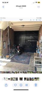 a view of a garage with a motorcycle parked in it at Althuizenhof - Jelle in Doenrade