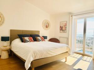 a bedroom with a large bed and a window at Villa Azur Golf in Bandol +46 photos