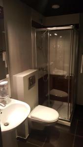 a bathroom with a shower and a toilet and a sink at Café Hôtel de l'Avenir in Saint-Ouen