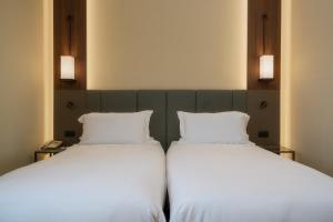 A bed or beds in a room at Hotel Mozart