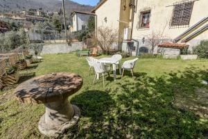 a patio with a table and chairs in a yard at Casa Gabriella in Vaiano