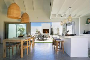 a kitchen and dining room with a table and chairs at The Cottage Collection Paternoster in Paternoster