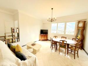 a living room with a table and a dining room at Le balcon du Hautacam in Argelès-Gazost
