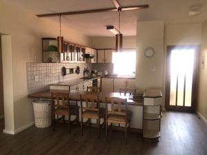 a kitchen with a table and chairs in a room at Sonneneck 7 in Swakopmund