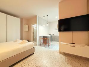 a bedroom with a bed with a flat screen tv at Il Giardino degli Ulivi PT in Lissone