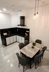 a dining room with a table and chairs at Soga Homestay 6 Rooms 4 Baths New House in Batu Pahat