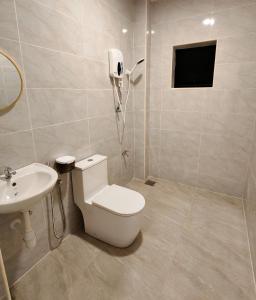 a bathroom with a toilet and a sink at Soga Homestay 6 Rooms 4 Baths New House in Batu Pahat