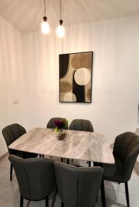 a dining room with a marble table and chairs at Soga Homestay 6 Rooms 4 Baths New House in Batu Pahat +23 photos