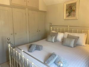 a bedroom with a bed with two blue pillows at Little Dolly sea view 2 bedroom apartment, St Ives town, dog friendly in St Ives