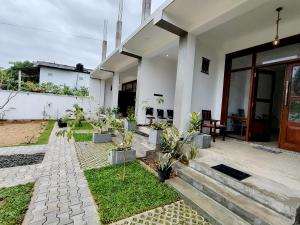 a house with a bunch of plants in the yard at Surfing Pinthaliya - Midigama in Weligama