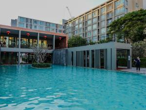 a large pool of water in front of a building at Dcondo Near the Mall,Doi Suthep View in Chiang Mai