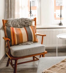 a rocking chair with a pillow on it in a room at Amalie Genusskult in Speyer