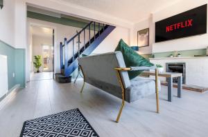 a living room with a chair and a staircase at Columbia - Sleeps 5, WiFi, Parking, Netflix, Near Observatory in Sutton in Ashfield