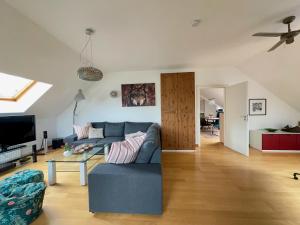 a living room with a blue couch and a table at Ferienwohnung am Berliner Stadtrand in Berlin