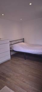 a bedroom with a bed and a dresser in it at Hameau de Soissons in Billy-sur-Aisne