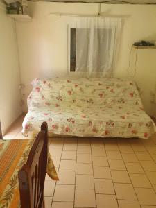 a bedroom with a bed and a window and a chair at Hameau de Soissons in Billy-sur-Aisne