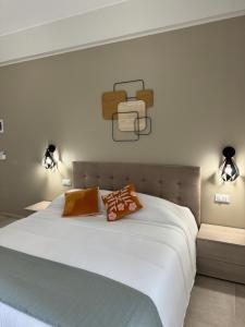 a bedroom with a large white bed with two pillows at Dimora dei Vespri 2 in Catania