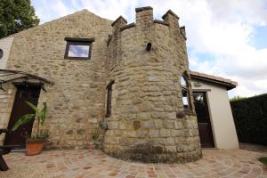 a stone house with a stone wall at Gite 1815 avec sauna privatif in Braine-lʼAlleud