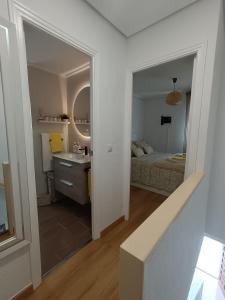 ein Zimmer mit einem Schlafzimmer mit einem Bett und einem Spiegel in der Unterkunft Casa Teo. in Santa Pola + 47 Fotos