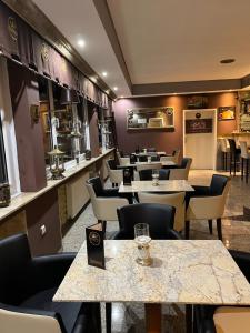 a restaurant with rows of tables and chairs at Hotel Royal in Bad Salzuflen