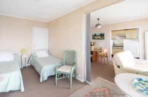 a bedroom with a bed and a living room at Appartement avec vue sur la mer à La Baule 62 m² tout équipé in La Baule +4 photos