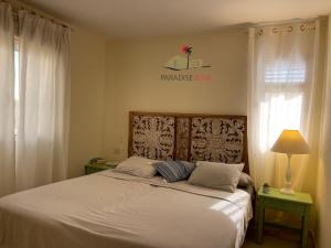 a bedroom with a large bed with white sheets at Villa Bonita in Corralejo +18 photos
