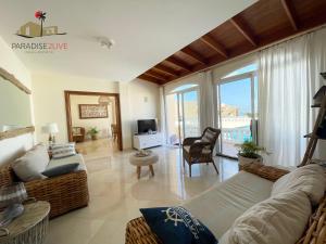 a living room with a couch and a tv at Villa Bonita in Corralejo