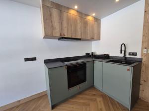 eine Küche mit Spüle und Arbeitsplatte in der Unterkunft ROCH B300 - Magnifique studio - Centre Bourg Saint Maurice in Bourg-Saint-Maurice