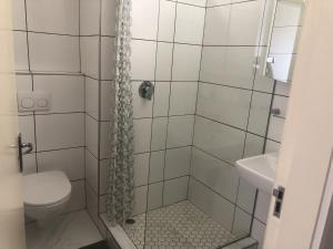 a bathroom with a shower with a toilet and a sink at Sonneneck 7 in Swakopmund