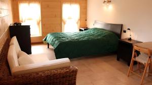 a bedroom with a bed and a desk and a chair at Agriturismo Prisma in Villa Vergano