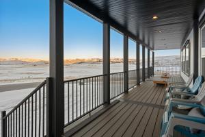 a porch with chairs and a view of the desert at Beautiful New Home - Access to Ideal Beach Resort in Garden City