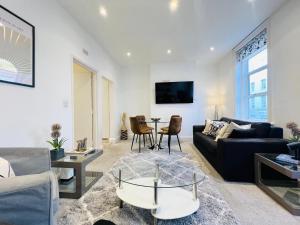 a living room with a couch and a table at Stylish Central Flat Steps From Oxford Street! in London +7 photos