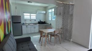 a kitchen with a table and chairs in a room at Beachtown Luxury Villas Apt 102 in Aguacate