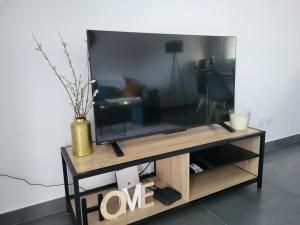 LucingesにあるAppartement Ilenaの木製エンターテイメントセンターの上に座って薄型テレビを設置