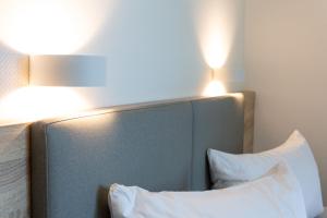 a bed with two lights on top of it at Hotel Seebrücke in Lubmin