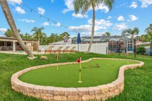 a golf course in a park with palm trees at Waterfront Oasis Htd Pool PuttPutt Bocce Ball in Redington Shores