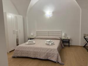 Un dormitorio con una cama con dos toallas encima. en Luna Apartments Tivoli, en Tívoli