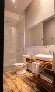 a bathroom with a toilet and a sink and a shower at Hotel Plaza de Armas in Querétaro