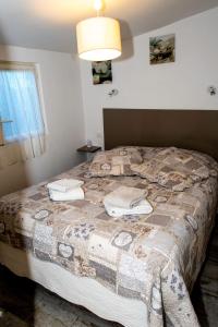 a bedroom with a bed with a blanket on it at Chalet in Plouër-sur-Rance