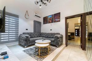 a living room with a couch and a table at Ruby 1 in Lagos