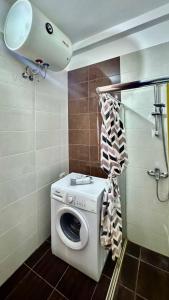 a washer and dryer in a bathroom with at 4 Seasons Sea View Apartment in Sarandë +35 photos