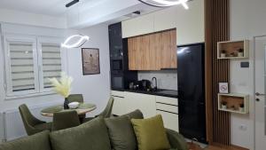 a living room with a couch and a table in a kitchen at Apartman Biser Vranja - FREE PARKING - CITY CENTER in Vranje +49 photos