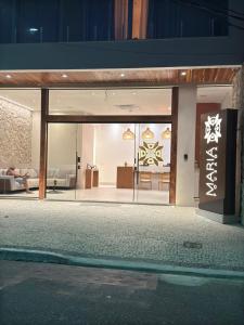 Edificio con puerta de cristal y sala de estar en Pousada Mariá, en Cabo Frío