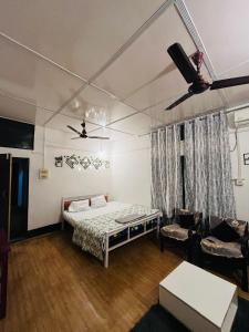 a bedroom with a bed and a ceiling fan at Riverdale Nest in Guwahati