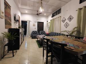 a living room with a table and chairs and a couch at Riverdale Nest in Guwahati