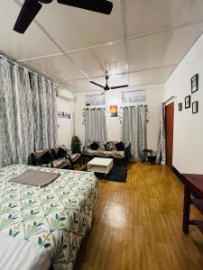a living room with a bed and a couch at Riverdale Nest in Guwahati