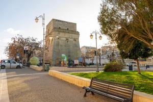 a bench in a park with a castle in the background at Albachiara in Bari