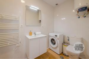 a white bathroom with a washing machine and a washer at Tu balcón en Madrid para 3, Carretas 25 in Madrid +16 photos